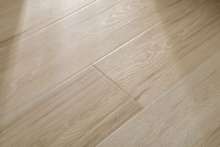 Light beige wood-look flooring planks with a natural grain pattern, shown in a close-up view.