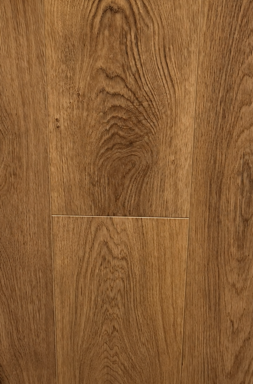 Close-up of warm medium-brown wood flooring planks with visible grain patterns and a horizontal seam near the center.