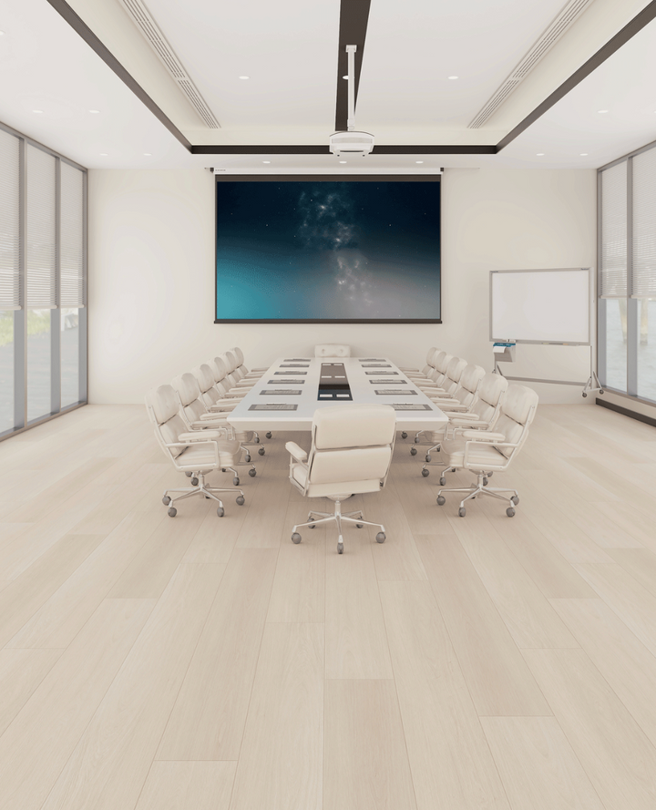 Modern conference room with a large screen and white chairs.