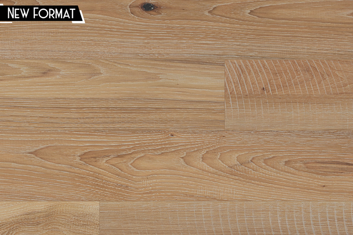 Light oak wood flooring planks with visible grain patterns and a small black label in the top-left corner that reads 'NEW FORMAT'.
