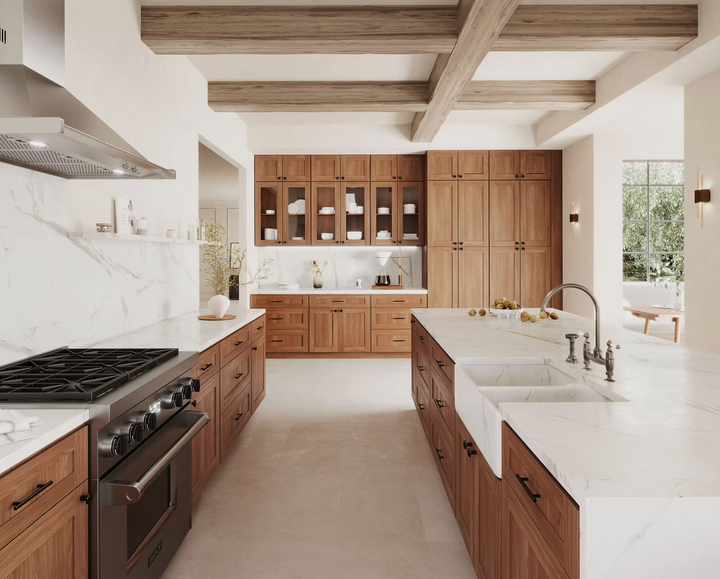Modern kitchen with wooden cabinets, marble countertops, and stainless steel appliances.