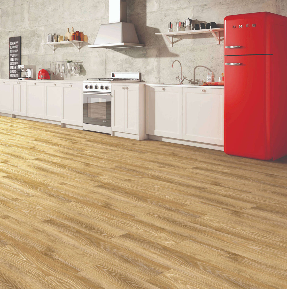 Light oak wood laminate flooring shown installed in a modern kitchen setting with white cabinets, a red retro-style refrigerator, and a gray tiled wall.