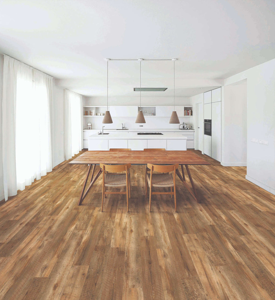 Modern kitchen with wooden dining table and chairs on a wooden floor.