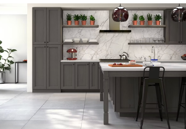 Modern kitchen with gray cabinets, marble countertops, and decorative plants.