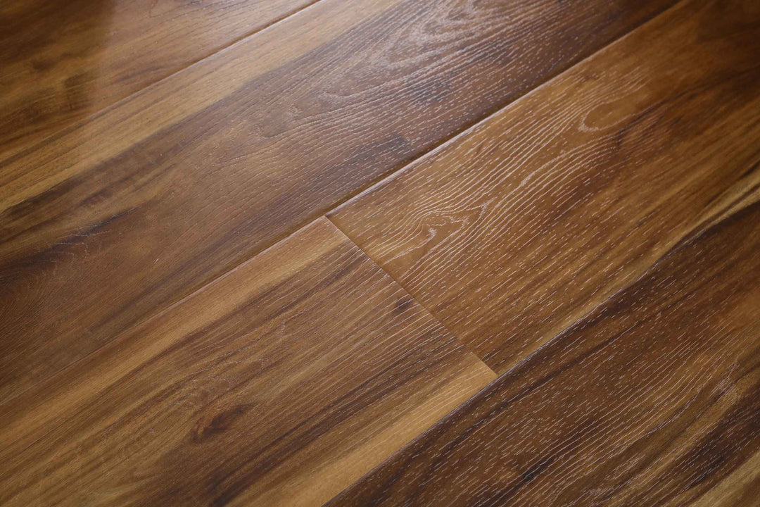 Close-up of warm medium-brown wood flooring planks with visible grain patterns and a glossy finish.