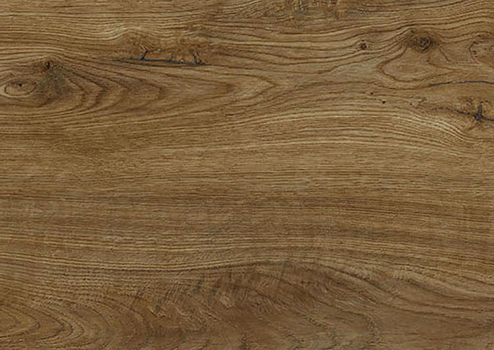 A close-up view of a wood grain surface with natural brown tones, visible knots, and swirling grain patterns.