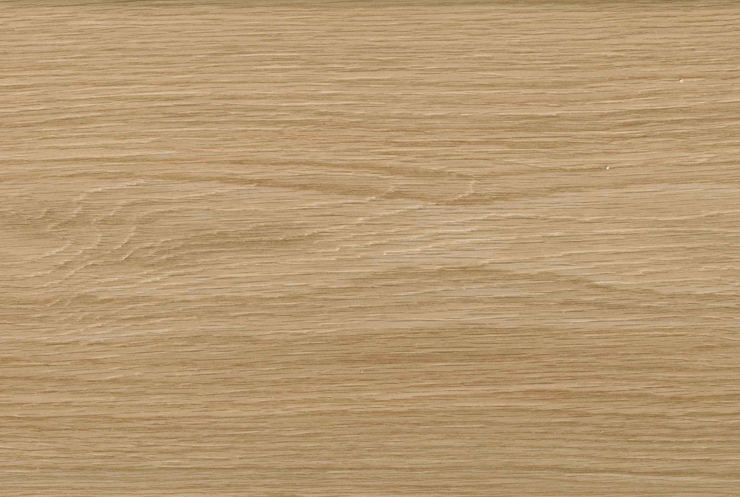 A close-up texture of a light oak wood grain surface, showing natural horizontal lines and subtle variations in tan and beige tones.