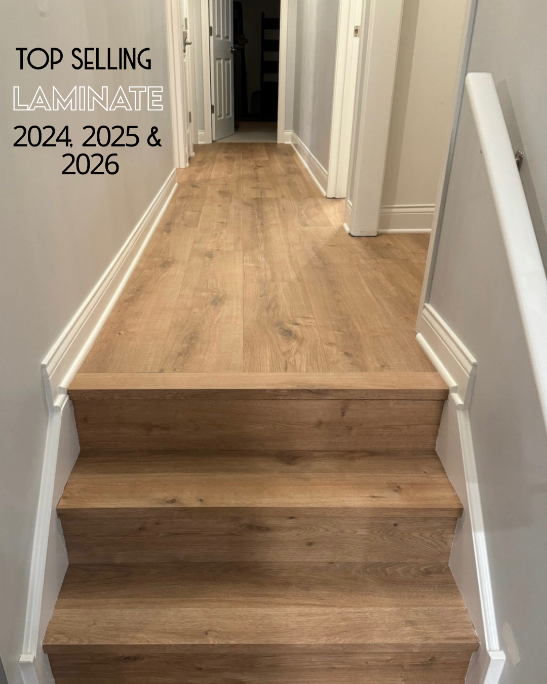 A wooden staircase and hallway with light oak laminate flooring, featuring white baseboards and walls. Text in the top-left corner reads 'TOP SELLING LAMINATE 2024.