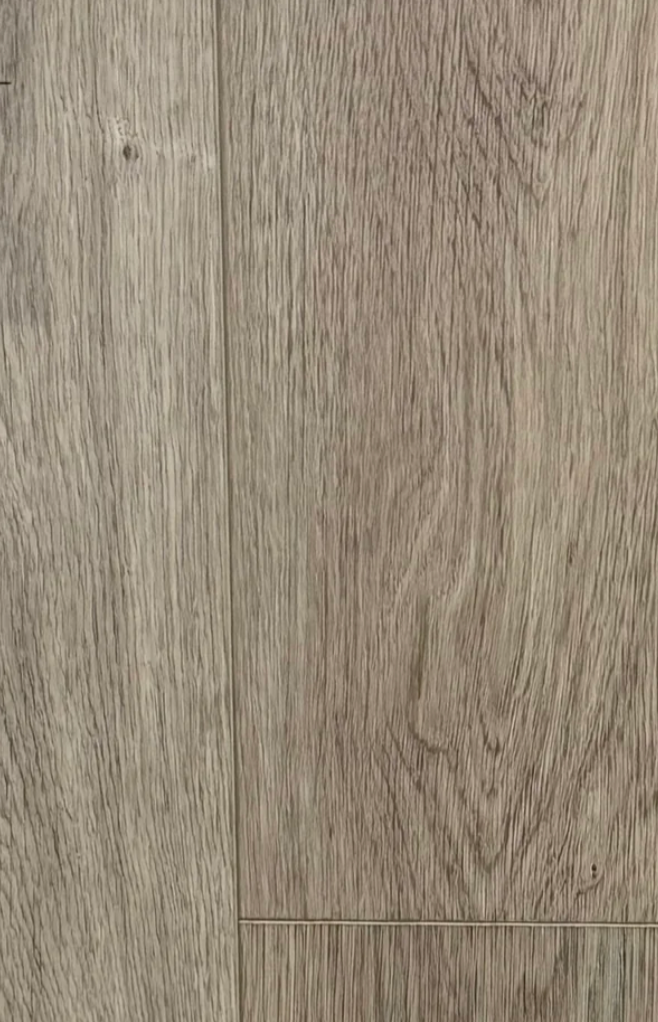 A close-up view of light brown wood flooring planks with visible grain patterns and seams.