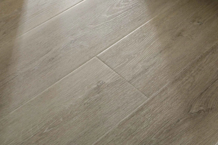 Light oak wood flooring planks with a natural grain texture and subtle warm beige-brown tones.