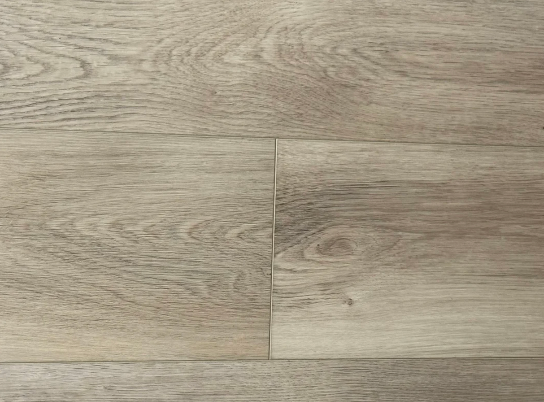 Light oak wood flooring planks with visible grain patterns and a central seam.