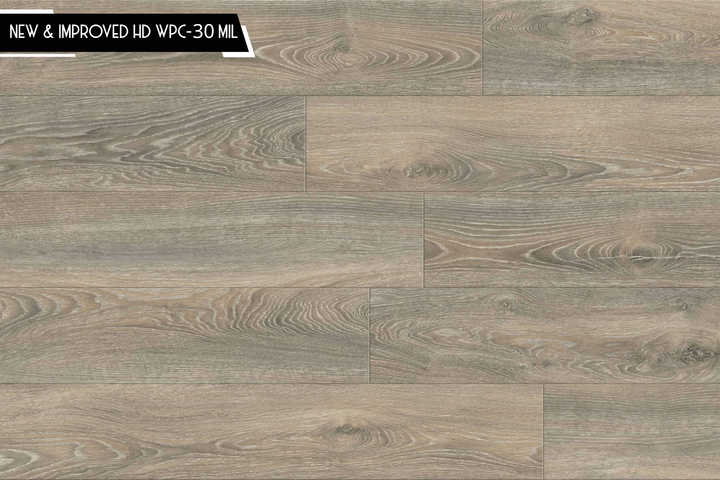Wood-look flooring planks in a weathered taupe-gray finish, showing natural grain and knot patterns. A black banner in the top-left corner reads 'NEW & IMPROVED HD WPC-30 MIL'.