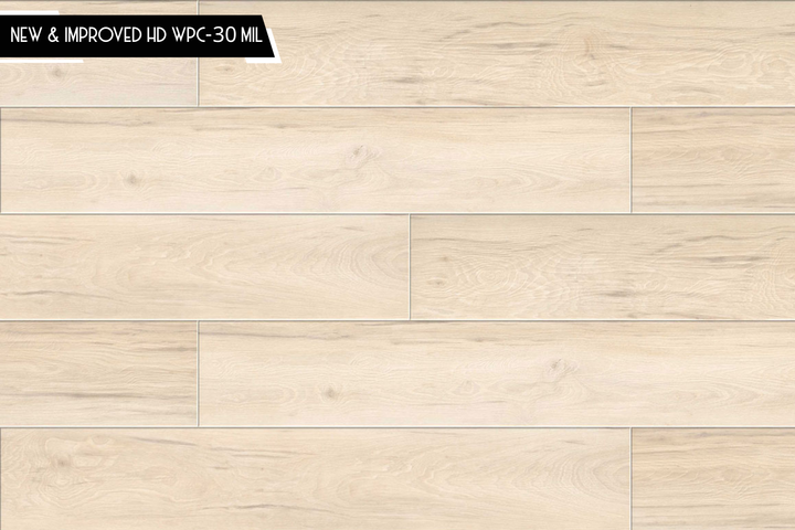 Light beige wood-look flooring planks with a natural grain pattern, featuring a small black banner in the top-left corner that reads 'NEW & IMPROVED HD WPC-30 MIL'.