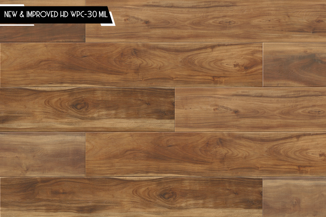 Brown wood-look flooring planks with visible grain and a small black text banner in the top-left corner reading 'NEW & IMPROVED HD WPC-30 MIL'.