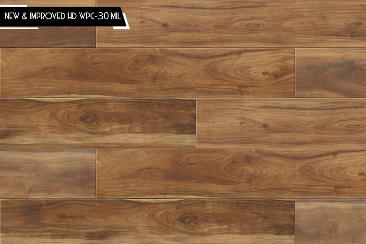 Brown wood-look flooring planks with visible grain and a small black text banner in the top-left corner reading 'NEW & IMPROVED HD WPC-30 MIL'.