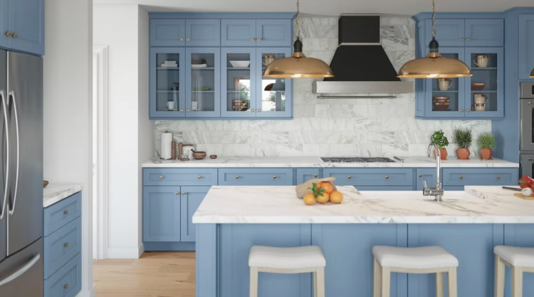 Modern kitchen with blue cabinets, white countertops, and stainless steel appliances.